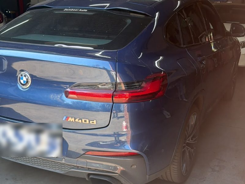 A blue BMW X4 M40d in the Q&A Auto Repairs workshop