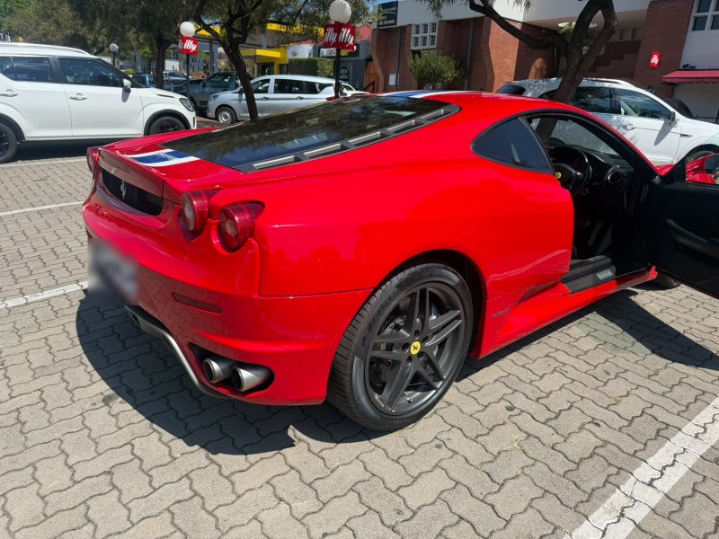 A red Ferrari F430 outside Q&A Auto Repairs in Ashlea Gardens